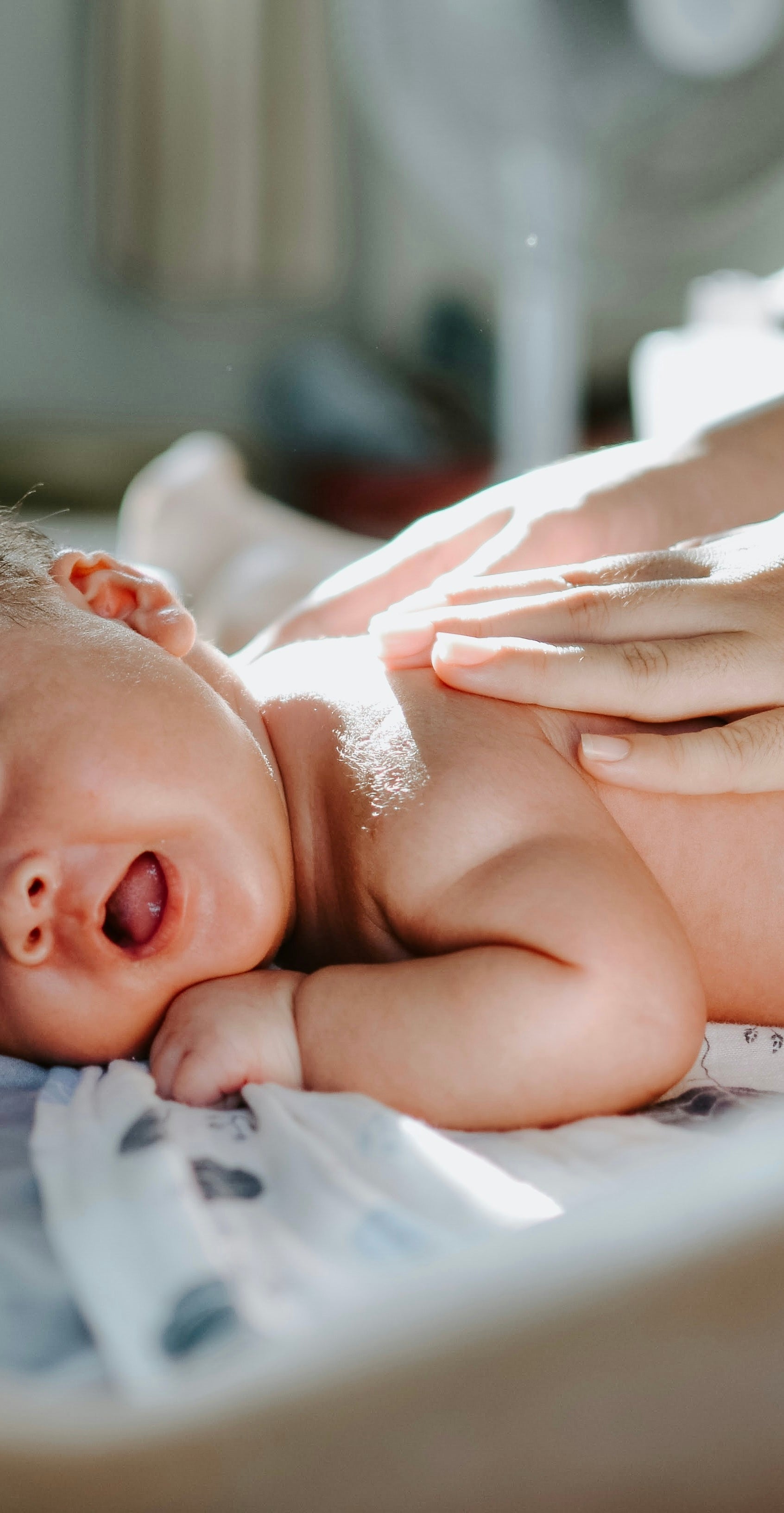 Parent applying TALEO Baby Balm to newborn — gentle grass-fed tallow skin care for babies, fragrance-free and hypoallergenic